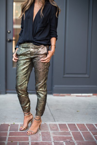 Black V-neck blouse and slim fitting pants with gold sequins