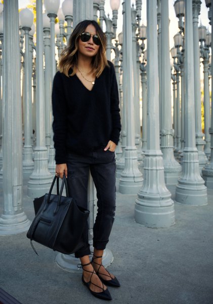 Black V-neck chunky sweater, slim-fit jeans and velvet strappy flat shoes