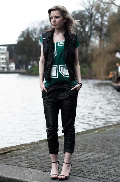 black vest with gray printed t-shirt and leather pants