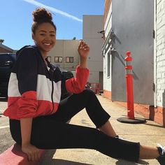 Black, white and red windbreaker with short skinny jeans