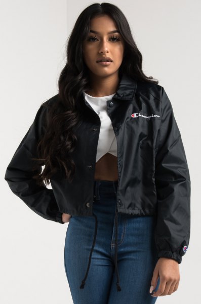 Black windbreaker with white graphic t-shirt and high-rise skinny jeans