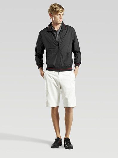 black windbreaker with white knee length shorts
