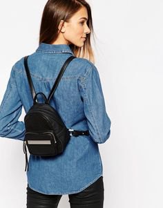 blue button down chambray shirt and black small backpack handbag
