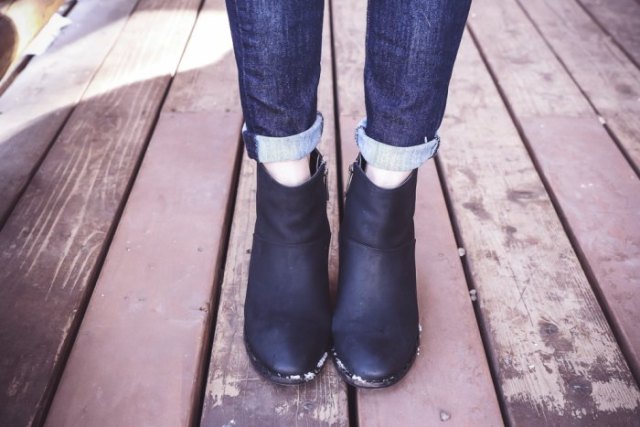 Blue cuffed slim fit jeans and black zipped ankle boots