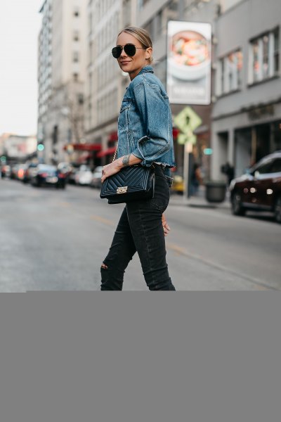 Blue denim jacket with black ankle-length skinny jeans and open heels