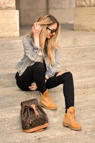 Blue denim jacket with black jeans and tan leather high-top shoes