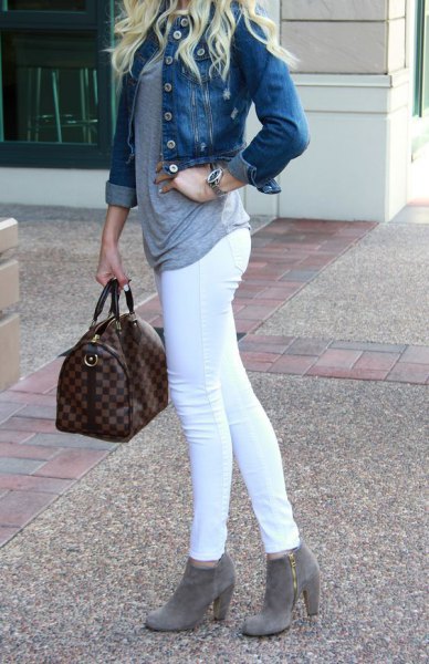 Blue denim jacket with white skinny jeans and gray heeled ankle boots