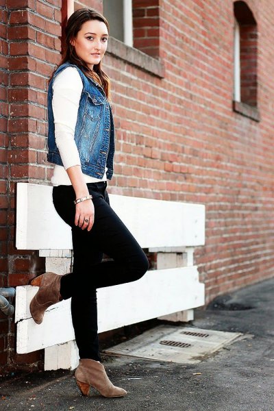 Blue denim motorcycle vest with white sweater and black jeans