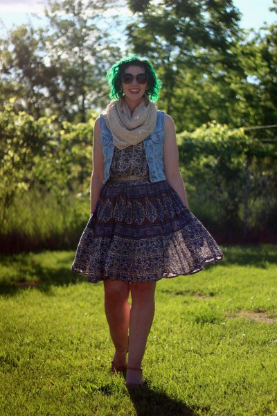 Blue denim vest with black lace dress with tribal pattern and flared cut