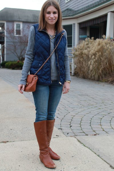 blue quilted vest with gray long-sleeved shirt and brown knee-high
boots