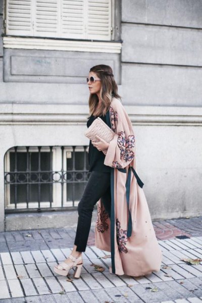 blush maxi coat with black top and matching skinny jeans