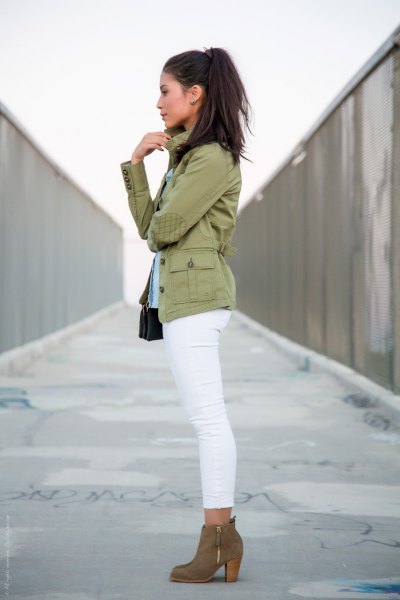 Light pink military jacket with white ankle length skinny jeans and
camel boots