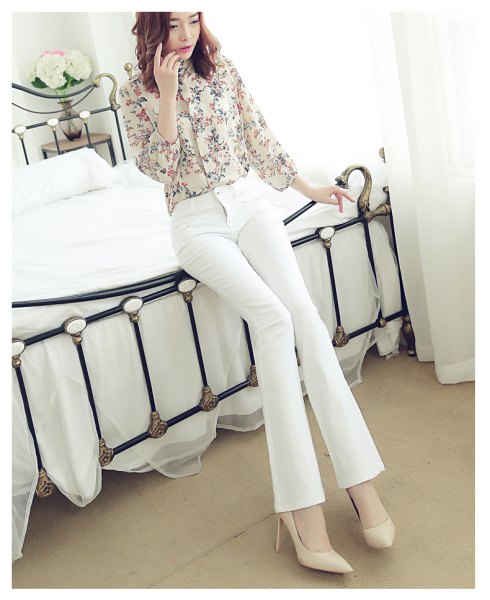 Pale pink printed button down shirt and white jeans