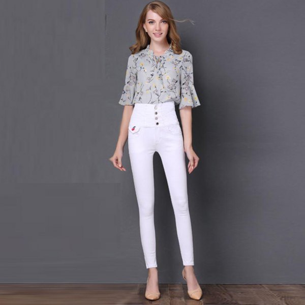 Pale pink printed chiffon blouse with bell sleeves and white jeans with button front and high waist