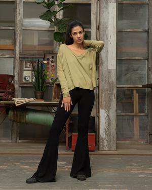 Soft pink, loose-fitting, long-sleeved t-shirt with black bell-bottoms