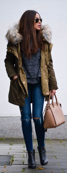 Brown longline bomber jacket with faux fur hood and ripped skinny jeans