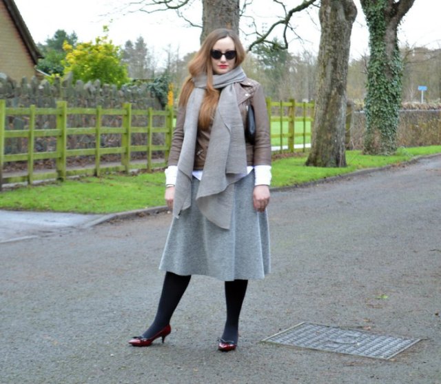 brown leather jacket with gray wool scarf and matching midi skirt