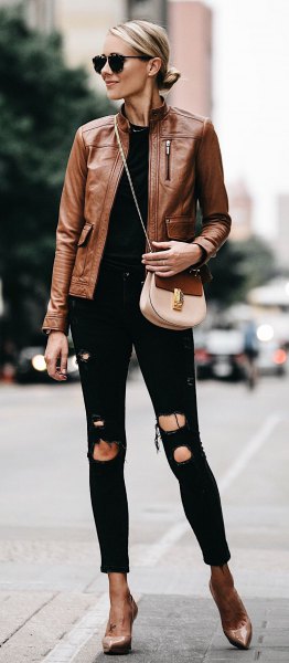 Brown leather motorcycle jacket paired with ripped cuffed black skinny jeans