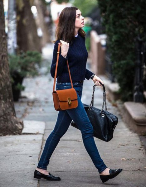 brown leather shoulder bag with black sweater and dark blue jeans