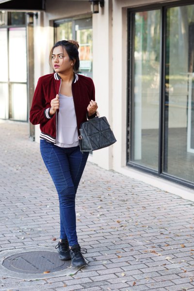 Burgundy velvet blazer with a gray scoop neck t-shirt and blue slim-fit jeans