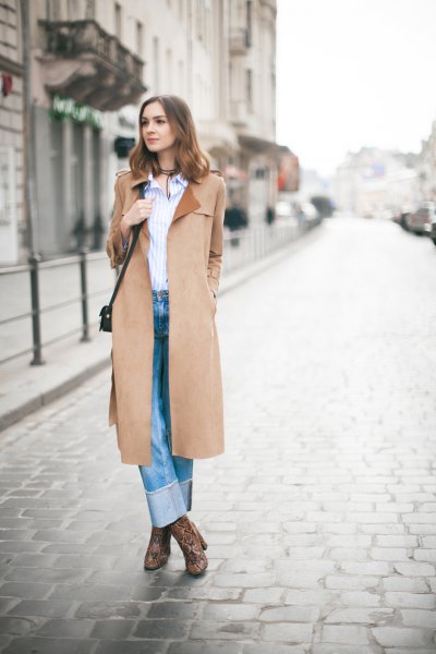 Camel coat with blue and white vertical striped shirt and cuffed jeans