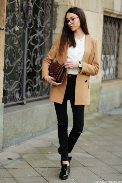 Camel colored double breasted blazer with white blouse and black
skinny jeans