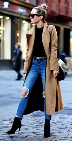 Camel colored maxi wool coat with black top and ripped blue jeans