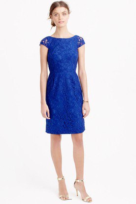 Royal blue cap sleeve knee length dress with gathered waist and silver heels