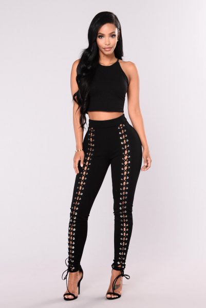 Crop top with black tight lace-up trousers and open heels