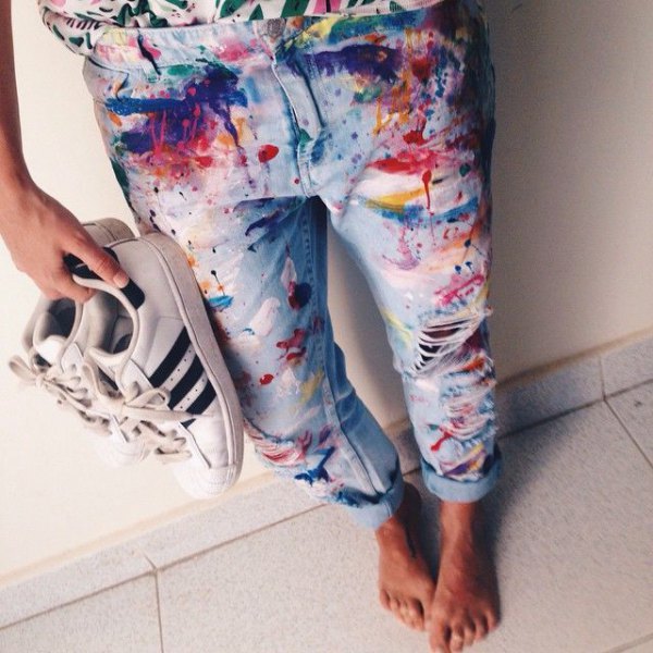 Brightly painted cuffed boyfriend jeans and white sneakers