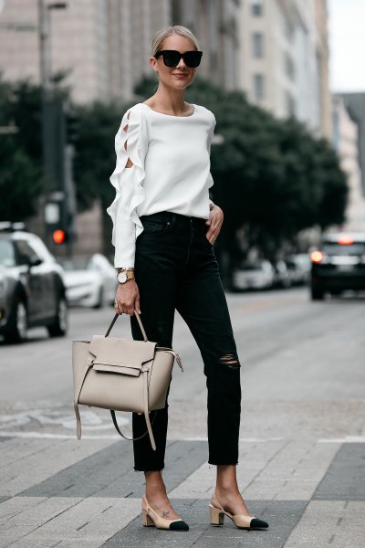 White sweater with cutouts, ankle length black jeans and pink heels