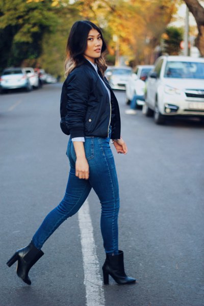 dark blue, tailored short bomber jacket with jeans and heeled boots