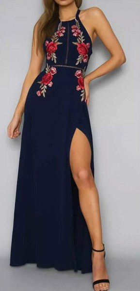 Navy blue halterneck maxi dress with a high slit and a floral
print