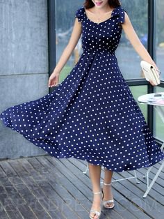 Dark blue polka dot flared maxi dress with silver heels