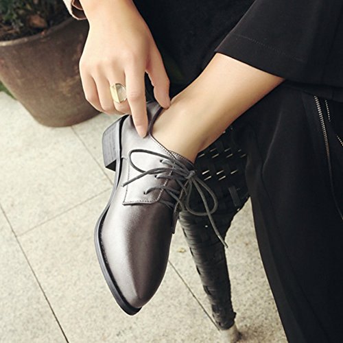 Dark leather heeled shoes and black straight leg chinos