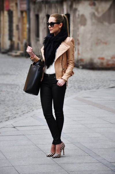 Black faux fur scarf worn with a brown leather jacket and striped heels