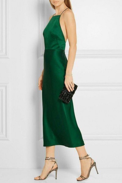Green silk fit-and-flare halterneck dress with clutch purse