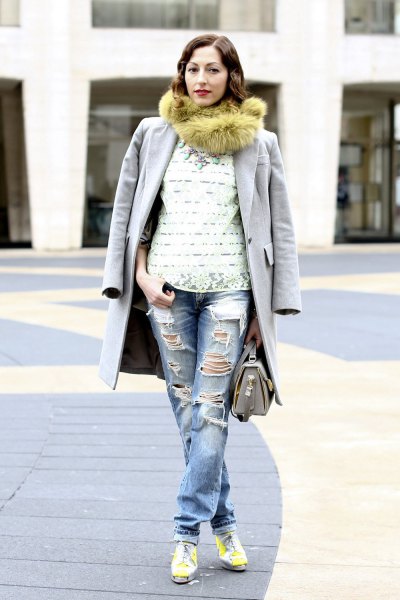 Green faux fur scarf worn with a long gray coat and boyfriend jeans