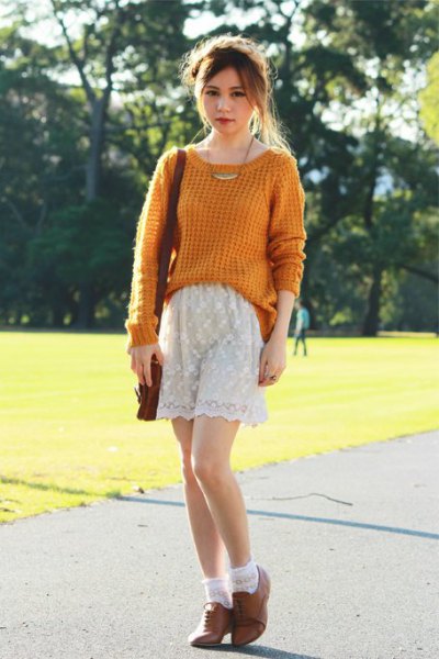Green knit sweater with white lace shorts and brown suede oxford shoes