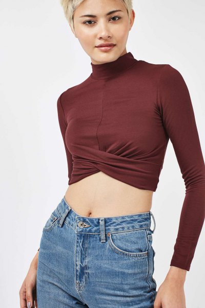 Green high neck long sleeve crop top and blue jeans