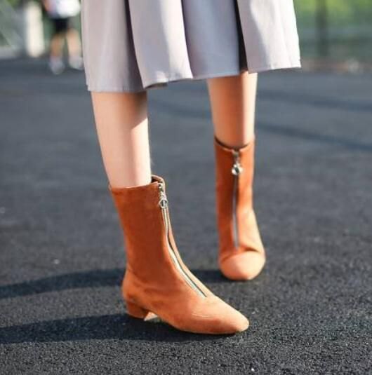 Green pleated midi dress with camel suede zip-up ankle boots