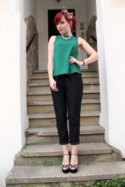 green sleeveless top with black cuffed pants