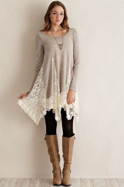 Gray and white long lace tunic top with black leggings and knee high boots