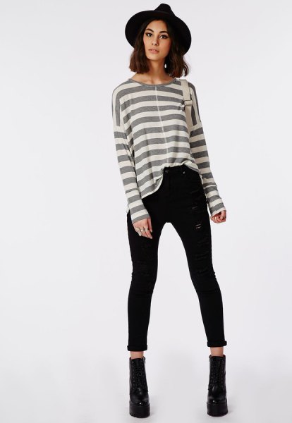 Gray and white striped long sleeve t-shirt paired with black skinny jeans with a high waist and cuffs
