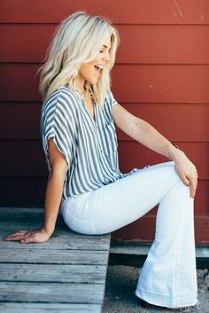 Gray and white striped short sleeve button down shirt paired with flared jeans