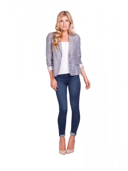 gray blazer with white top and dark blue drainpipe jeans with cuffs