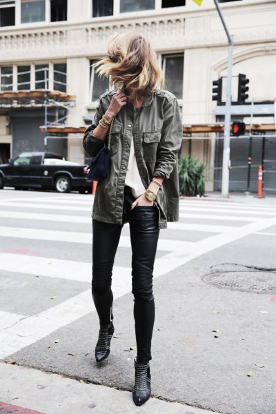gray denim jacket with black leather leggings and spiked ankle boots