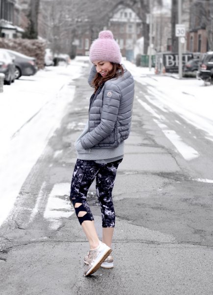 gray down jacket with black and white printed slim fitting leggings