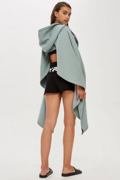 Gray draped hoodie with cutout back and black mini running
shorts