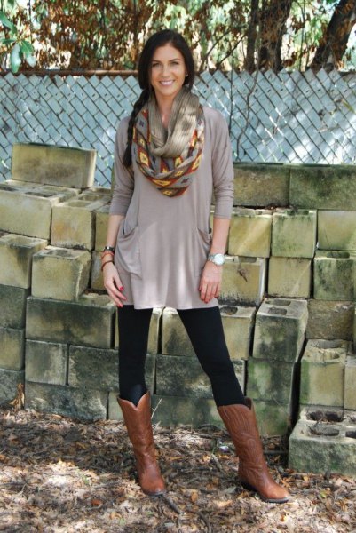 gray elegant tunic top with leggings and brown knee high leather boots